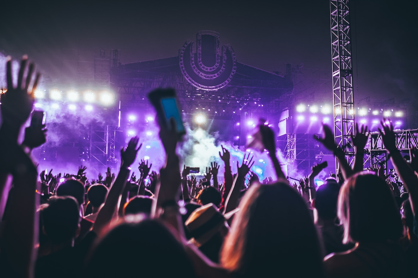 A festival crowd in front of a lit stage
